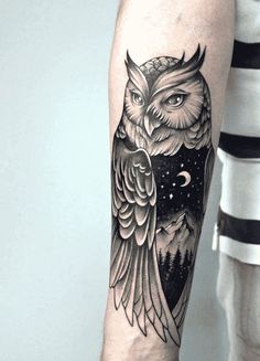 an owl tattoo on the arm with mountains and stars in the sky behind it is black and white