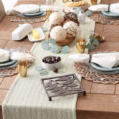 the table is set with bread, grapes and other food on it's placemats