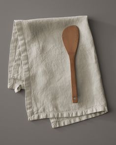 a wooden spoon sitting on top of a napkin