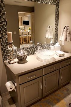 a bathroom with a large mirror and two sinks in front of the counter top,