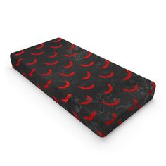 a black and red bed cover with birds on the bottom, in front of a white background