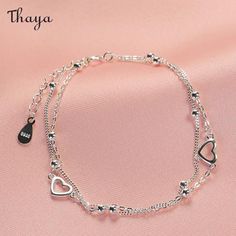 Design concept     The slender double-layered chain is lovely. The hollow love heart and round beads add a sweet touch, wrapping around the wrist and highlighting the slender and white wrist. How can spring outfits be missing this touch of sweetness, which will show delicate and soft beauty and charming temperament.     Detail    Brand: Thaya  Material: 925 Silver + oxidation  Gender:Female  Size: Chain length about 15+3cm extension chain, love about 0.9cm  Weight: About 1.78g Trendy Silver Bracelets With Heart Beads, Trendy Silver Heart Beads Bracelet, Elegant Double Chain Charm Bracelet, Double Heart Bracelet With Adjustable Chain, Trendy Silver Charm Bracelet With Heart Beads, Elegant Heart Jewelry For Spring, Elegant Heart Shaped Jewelry For Spring, Elegant Heart-shaped Jewelry For Spring, Minimalist Heart Beads Bracelet