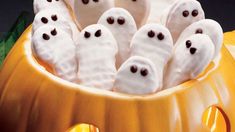 a group of ghost cookies in a pumpkin bowl