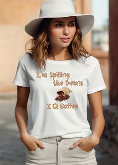 "Description: 👕 Are you looking for a wardrobe staple that perfectly encapsulates your love for coffee? Your search ends with our \"I'm spilling the beans; I love coffee\" t-shirt. Made from luxurious 100% airlume combed and ringspun cotton, this tee is more than just clothing; it's a statement of your unwavering passion for that daily cup of joy. The lightweight fabric ensures year-round comfort, while the stylish ribbed knit collars and shoulder taping provide a modern fit that complements any occasion. 👕 This funny coffee shirt with durable dual side seams and a retail fit doesn't just celebrate your love for java--it does so with unbeatable quality and timeless style. Available in various sizes, it's the perfect gift for the coffee connoisseur in your life, offering both comfort and Casual Coffee-colored Slogan Top, Coffee Crew Neck Top With Slogan, Coffee Colored Cotton Slogan Top, Coffee Cotton Slogan Top, Coffee Short Sleeve Top With Text Print, Coffee-colored Cotton Slogan Top, Coffee Colored Crew Neck Top With Slogan, Coffee-colored Cotton Tops With Slogan, Coffee Colored Text Print Crew Neck Top