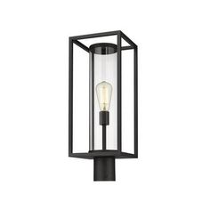 an outdoor post light with a clear glass shade on the top and black metal frame