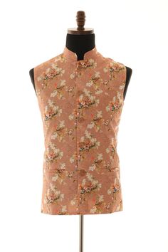 This Readymade Dark Peach floral Sleeveless attire is Harvest with thread work. this Nehru jacket is made of art silk fabric and embroidery with the same color thread and a magnificent floral print which is Enhanced with sequences, Buttons, and Crafted in a mandarin Collar Neck. Specifications Sleeve Length - Sleeveless Lined with Polyester and rayon lining L is around 28 inches for size 40  Jacket Length depends on sizes Top Shape - Straight Top Hemline - Straight Neck - Mandarin Collar Jacket Pattern - Floral Size 38 to 50 Available NOTE: THE COLOR IS A LITTLE DARKER THAN IT APPEARS ON SCREEN DUE TO DIGITAL PHOTOGRAPHY. WASH CARE INSTRUCTIONS - Please dry clean only when it is applicable. Indian Traditional Wear, Mandarin Collar Jacket, Indian Party, Indian Party Wear, Nehru Jacket, Nehru Jackets, Collar Neck, Collar Jacket, Indian Traditional