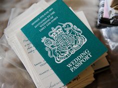 a green and white passport sitting on top of plastic