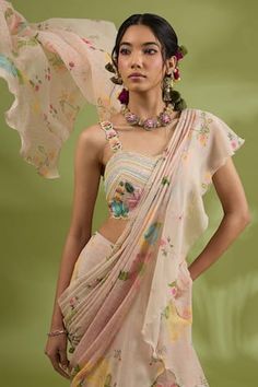 Pink pre-draped saree with all over flower print and ruffle detailing. Paired with a padded blouse with floral motif and linear hand embroidery and an embroidered belt with attached cori shells. - Aza Fashions Draped Sets With Floral Embroidery In Georgette, Summer Wedding Saree With Ruffles, Elegant Floral Embroidery Pre-draped Saree, Summer Wedding Pre-draped Saree With Ruffles, Summer Wedding Pre-draped Ruffled Saree, Fitted Ruffled Dupatta, Summer Reception Draped Dress, Floral Print Blouse Piece For Wedding, Elegant Summer Saree With Floral Print