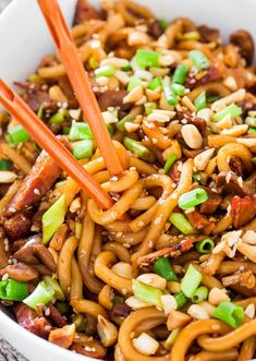 noodles with carrots, celery and peanuts in a bowl