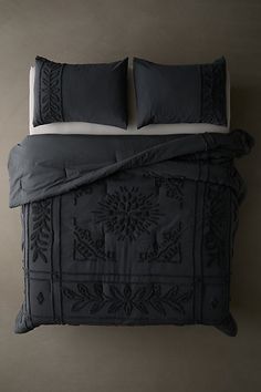 a bed with two pillows on top of it