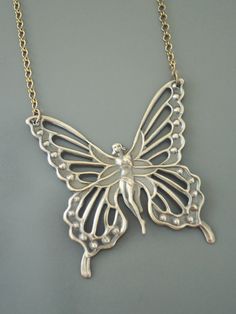 "Vintage Jewelry - Vintage Necklace - Butterfly Fairy Necklace - Butterfly Necklace - Brass Necklace - Boho Necklace - Chloe's Vintage handmade jewelry This is such a beautiful vintage brass necklace! A large Art Nouveau butterfly fairy. It hangs from a pretty vintage brass ladder chain necklace. So very bold and feminine. Chloe says, \"Wear it and feel fabulous!\" The pendant is 2 1/8\" wide and 2 1/4\" tall. You can choose the necklace length you would like at checkout. Thanks for visiting Chl Handmade Butterfly Necklaces In Fairycore Style, Handmade Butterfly Fairycore Necklaces, Handmade Silver Fairy Necklace, Handmade Fairycore Butterfly Necklaces, Handmade Fairycore Butterfly Necklace, Handmade Gold Fairy Necklace, Handmade Fairy Gold Necklace, Necklaces Butterfly, Necklaces Boho