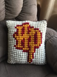 a decorative pillow on a couch in the living room