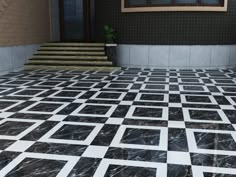 a black and white tiled floor with stairs