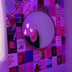 there is a mirror on the wall with pictures all over it and lights in the corner