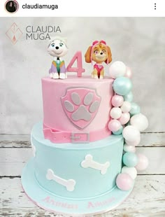 there is a three layer cake decorated with dogs and balloons