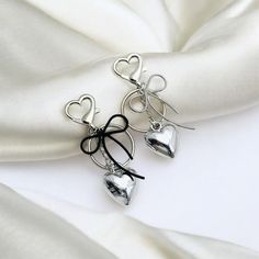 Embrace the nostalgic charm of Y2K fashion with this Silver Metal Heart Charm Keychain, a perfect blend of retro style and modern coquette aesthetics. Crafted with a shiny silver finish and a delicate heart charm, this keychain is designed to add a touch of elegance and personality to your car keys or backpack. Ideal for those who love the playful and feminine vibe of the coquette style, this accessory is not just a keychain but a statement piece that complements your unique fashion sense. Wheth Modern Coquette, Keychain Aesthetic, Coquette Style, Charm Keychain, Metal Heart, Trendy Gift, Retro Stil, Car Keys, Shiny Silver