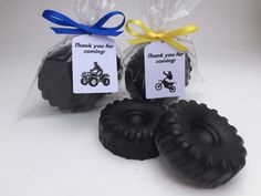 two black soaps with tags on them sitting next to each other in plastic bags