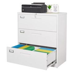 an office file cabinet with two drawers and a printer sitting on top of one drawer