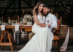 a bride and groom sitting at a wooden table