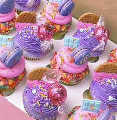 cupcakes decorated in pink, purple and blue icing