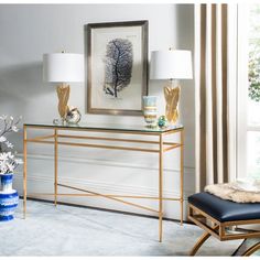 a living room scene with focus on the console table and two lamps, along with an art piece