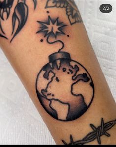 a black and white photo of a tattoo on someone's arm with the earth in it