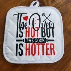 a pot holder with the words, the oven is hot