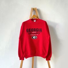 Vintage University of Georgia Bulldogs sweatshirt/ M * PLEASE READ BEFORE PURCHASE * PLEASE consider the PHOTOS before making the decision * The images may DIFFER in appearance from the actual product because we took pictures under daylight.  * PLEASE send your PHONE NUMBER after your purchase for the shipping company to contact you X No returns X No refund Condition : 8/10 More details : faded color/ look at the pictures  Brand : Jerzees Size On Tag : M Pit to pit/ Chests : 22/44 inches  Length : 27 inches  Material : cotton polyester  Color : red * Payment accept PayPal only * ALL ITEMS are VINTAGE which may show some signs of wear and tear * Due to the different display and different light, the picture may not reflect the actual color of the item Thank you RE/22/6/23 Asb Shirts, Bulldogs Sweatshirt, Vintage University, Arizona State University, Shipping Company, New Orleans Saints