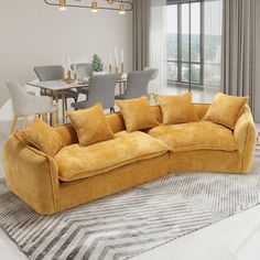 a living room filled with furniture next to a dining room table and window covered in curtains