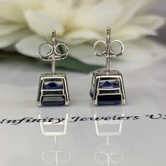 These earrings are asscher cut lab created blue sapphire studs, 14k white gold #6356 -Approximate total carat weight: 3.50ctw diamond equivalent -Center Stone Size: approx. 1.75ct each diamond equivalent -Gem Type: lab created blue sapphire -Stone Shape: asscher cut 7x7mm -Stone Clarity: VS2 -Stone Color: Brilliant Blue, Eye-Clean -Mohs Scale: 9 hardness -Metal Type and Purity: 14k white gold -Setting: 4 prong basket setting -Backing: friction back (earring backs are subject to change due to ava Blue Sapphire Earrings, Blue Sapphire Studs, Mohs Scale, Basket Setting, Sapphire Studs, White Gold Set, Asscher Cut, Blue Eye, Sapphire Earrings