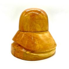 a wooden object that looks like it has been carved into the shape of a hat