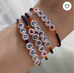 three bracelets with beads that say red, white, and blue on the wrist