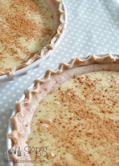 two pies sitting on top of a white table cloth