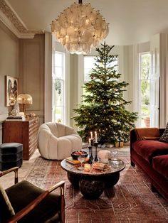 a living room filled with furniture and a christmas tree in the middle of the room