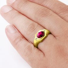 Make a statement with this delicate solitaire ring, featuring a rich ruby gemstone complimented by sparkling diamonds and framed in 10k yellow gold.Metal:10K Yellow GoldRuby: carat total weight - 2.400.7cm x 0.9cmsetting - bezel settingDiamonds:carat total weight - 0.02color - Hclarity - VS1setting - pave setting