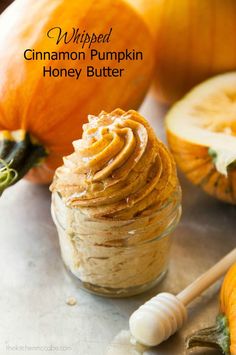 a jar filled with peanut butter next to pumpkins