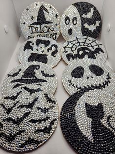 four halloween coasters with black and white designs