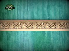 an ornate wooden frame on a green background