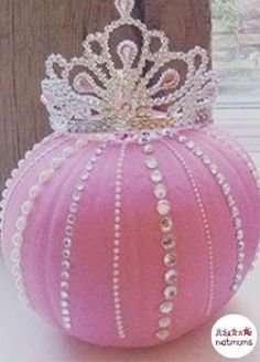 a pink ball with a tiara on top