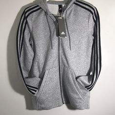 Brand New Adidas Essentials Cotton Fleece 3- Stripe Full Zip Hoodie Heather Grey/ Black Stripes Basic 3 Stripe Timeless Adidas Style All Around Comfort Zip Up Closure Retro Look Adidas Sportswear Hoodie With Three Stripes, Winter Athleisure Outerwear With Side Stripes, Winter Adidas Activewear With Three Stripes, Adidas Hoodie With Three Stripes For Sports Season, Winter Athleisure Outerwear With Contrast Stripes, Athleisure Outerwear With Contrast Stripes For Winter, Sporty Striped Sweatshirt For Winter, Sporty Striped Hoodie With Drawstring, Adidas-style Winter Sportswear Activewear