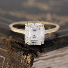 As timeless they come - a stunning asscher cut diamond set simply in a 4-prong setting. The diamond has a beautiful, almost perfect square shape and crisp faceting and on the finger, the look is just mesmerizing. Low set on the finger, and a wedding band should stack nicely too! 18kt yellow gold, size 6, and fully siza Ascher Cut Diamond Engagement Ring, Asscher Cut Engagement Ring, Asscher Cut Diamond Engagement Ring, Yellow Gold Anniversary Rings, Modern Mens Rings, Asscher Engagement Ring, Asscher Cut Engagement Rings, Art Jewelry Earrings, Ring Cuts