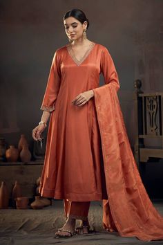 Rust orange kalidar kurta with pita embroidered neckline. Comes with pant and tissue lines dupatta. - Aza Fashions Orange Color Kurti Design, Orange Kurta Woman, A Line Suits Indian, Festive Orange Set With Sheer Dupatta, Orange Chanderi Set With Gota Work, Orange Anarkali Chanderi Sets, Festive Orange Palazzo Set With Straight Kurta, Orange Raw Silk Set With Dupatta, Orange Palazzo Set With Sheer Dupatta For Diwali