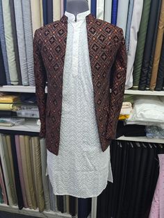 Product Description: Step into the world of refined elegance with our **Elegant Open Jodhpuri Jacket with White Kurta Pajama Set**. This ensemble is a harmonious blend of traditional Indian craftsmanship and contemporary fashion, designed to elevate your style quotient at any formal occasion. The set features a meticulously tailored Jodhpuri jacket adorned with a rich, intricate pattern and a classic white kurta pajama, creating a striking contrast that exudes sophistication and grace. **Jodhpur Kurta With Jodhpuri Jacket, Festive Long Sleeve Chikankari Bandhgala, Festive Long Sleeve Bandhgala With Chikankari Embroidery, Traditional Wedding Sets For Fall, Traditional Fall Wedding Sets, Wedding Sets With Zari Work For Fall, Fall Wedding Sets With Zari Work, Traditional Nehru Jacket For Fall Wedding, Traditional Blazer For Fall