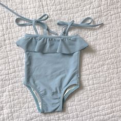 New Never Worn Size Is 6-12 Months Originally $71 Summer Solid Color Bodysuit For Playtime, Fitted Blue Bodysuit For Playtime, Blue Fitted Bodysuit For Playtime, Playful Light Blue Swimwear For Pool, Cute Blue Bodysuit For Swimming, Cute Blue Swimming Bodysuit, Cute Bodysuit For Summer, Playful Light Blue Swimwear For Spring, Cute Blue Bodysuit For Spring