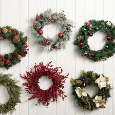 christmas wreaths are arranged on the wall