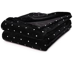 three black and white polka dot blankets stacked on top of each other