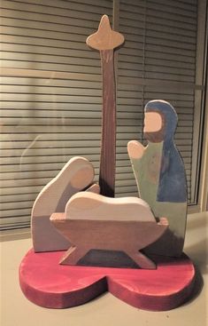 a wooden nativity scene with a baby jesus in the mangeracle and a star