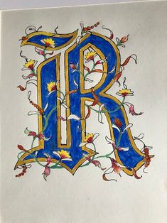 a drawing of the letter r with flowers and leaves on it's sides,