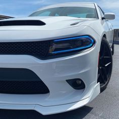 the front end of a white dodge charger