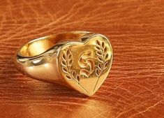 Your custom signet ring will be personalized with a family crest, symbol or logo. It's unisex and authentic 925 sterling silver. 24K gold filling is available. Vintage custom signet ring options include name engravings. It's perfect gift for your loved ones who like vintage rings and old jewelry. Customize your ring however you like and solid gold options can be made with a family crest also. Ask any question you might have! I respond instantly! ★ PROVIDED FREE OF CHARGE: ✓ Personalization, cust Heirloom Gold Engraved Ring For Commemoration, Antique Style Signet Ring With Engraving Option For Anniversary, Antique Initial Ring With Polished Finish For Anniversary, Luxury Engraved Signet Ring For Commemoration, Heirloom Engraved Ring For Commemoration With Hallmarks, Gold Engraved Signet Ring For Commemoration, Heirloom Engraved Heart Ring, Antique Personalized Signet Ring For Anniversary, Heirloom Engraved Signet Ring For Commemoration